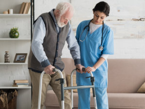 caregiver assisting senior man in walking
